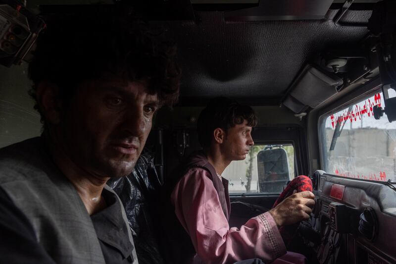 Ahmad Shah, 28, an Afghan policeman, sits in an police armoured vehicle after being rescued by Afghan Special Forces, in Kandahar province, Afghanistan, July 13, 2021.