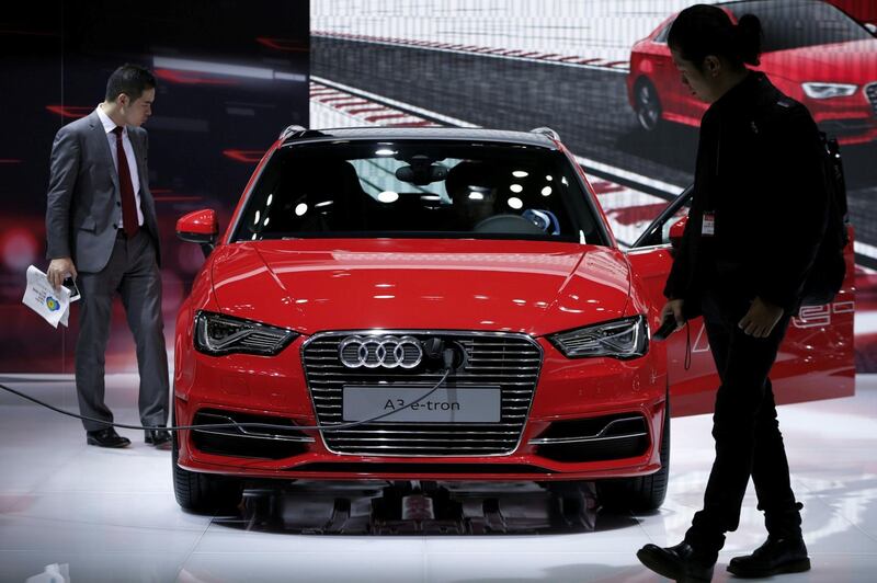 Attendees look at an Audi AG A3 e-tron electric vehicle on display at the 43rd Tokyo Motor Show 2013 in Tokyo, Japan, on Thursday, Nov. 21, 2013. The autoshow will be open to the public from Nov. 23 to Dec. 1 at the Tokyo International Exhibition Center, also known as the Tokyo Big Sight.  Photographer: Kiyoshi Ota/Bloomberg