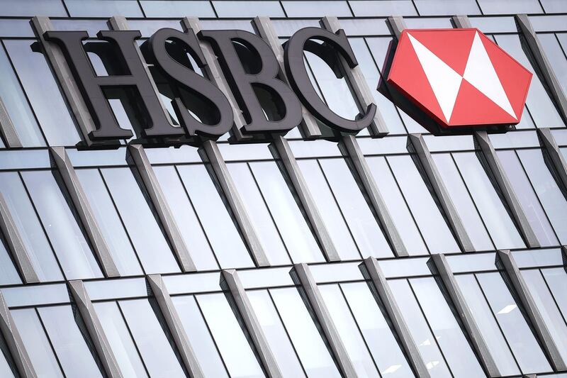 (FILES) In this file photo the HSBC logo is displayed on the facade of the HSBC headquarters in Milan on November 7, 2017.  HSBC on Tuesday said first quarter pre-tax profits almost halved as the banking giant was battered by the global coronavirus pandemic while it embarked on a major restructuring. / AFP / MARCO BERTORELLO
