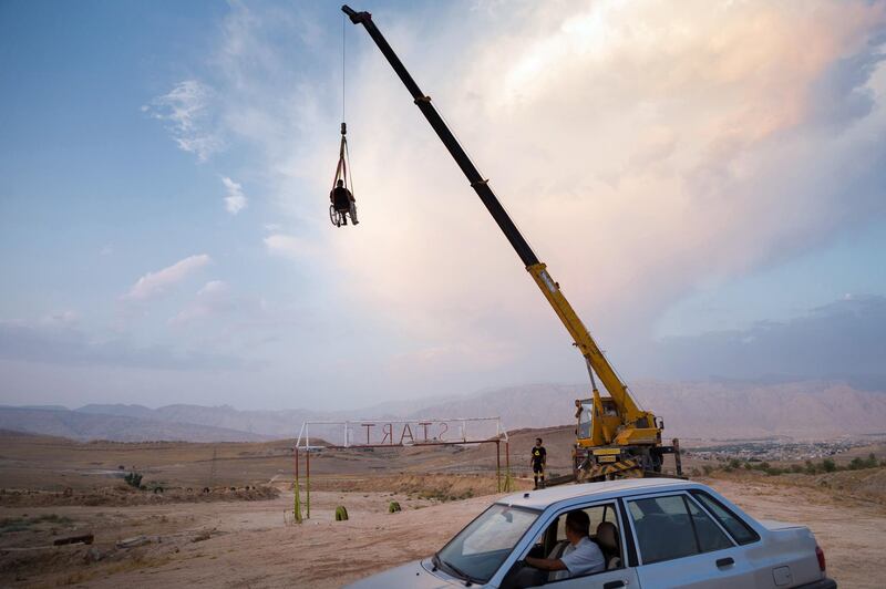 Saeed is climbing by a crane while sitting in a wheelchair at the Gachsaran motorcycle track on Sep 11, 2020 in Gachsaran city of Kohgiluyeh and Boyer-Ahmad province, Iran. 
He like to do things that others are afraid of.