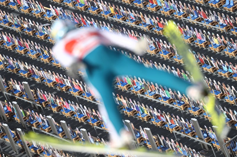 Nordic Skiing - FIS Nordic World Ski Championships - Oberstdorf, Germany - February 24, 2021  Cardboard spectators are seen as Finland's Jarkko Maatta jumps during the Men's Ski Jumping Training  REUTERS/Kai Pfaffenbach     TPX IMAGES OF THE DAY