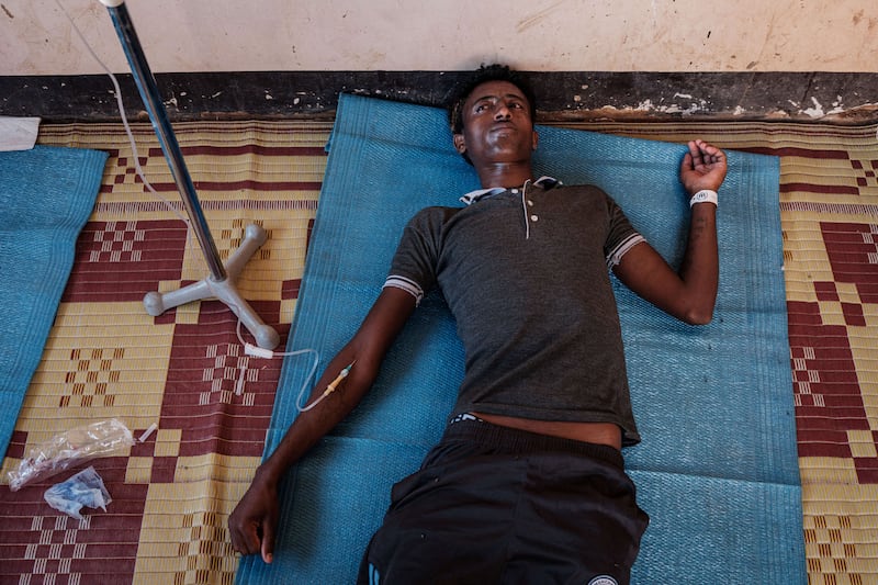 An Ethiopian refugee who fled Ethiopia's Tigray conflict is treated with a drip infusion of sodium chloride after being diagnosed with malaria and diarrhoea inside a clinic at the Um Raquba refugee camp in Sudan's eastern Gedaref state. AFP
