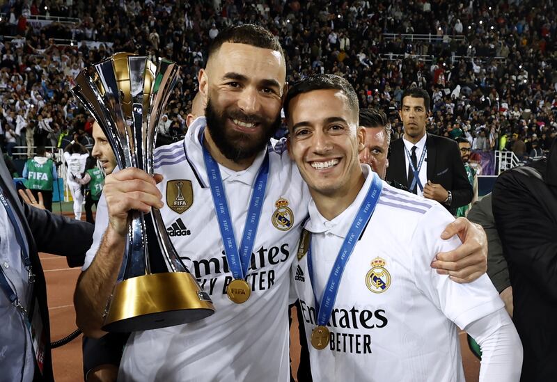 Karim Benzema and Lucas Vazquez celebrate with the Club World Cup trophy. EPA