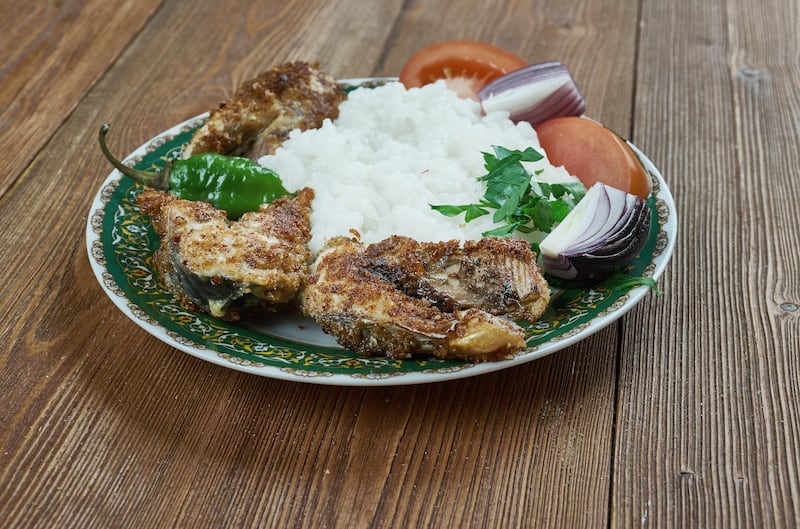 Panta bhat is made by soaking leftover rice overnight in water, which is then served with sides such as fish, pickle, chillies and fritters. Photo: Alamy