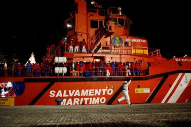Migrants, intercepted off the coast in the Mediterranean Sea, wait to disembark from a rescue boat at dawn at the port of Malaga, southern Spain. REUTERS