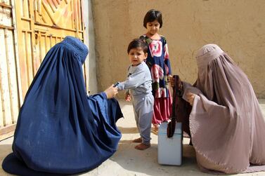 Health workers administer polio vaccines to children in Kandahar, Afghanistan. Muhammad Sadiq / EPA