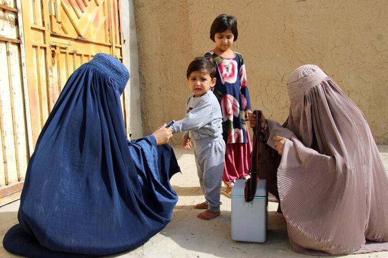 epa07922072 Afghan health workers administer polio vaccination to children in Kandahar, Afghanistan, 15 October 2019. Since the beginning of 2019 nineteen new polio cases have been reported, two from Kandahar and rest from other areas.  Afghanistan is one of the two countries along with neighboring Pakistan where polio is still endemic, crippling hundreds of children every year.  EPA/MUHAMMAD SADIQ