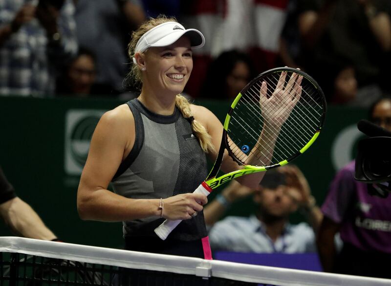 Tennis - WTA Tour Finals - Singapore Indoor Stadium, Singapore - October 25, 2017   Denmark's Caroline Wozniacki celebrates winning her group stage match with Romania's Simona Halep   REUTERS/Jeremy Lee