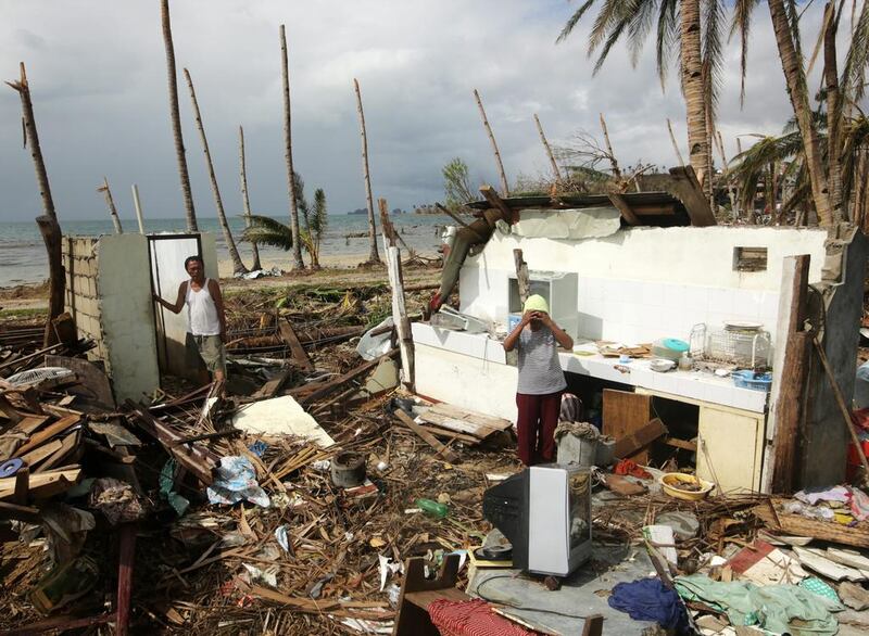 Filipino typhoon victims view what is left of their damaged home in the typhoon devastated town of Marabut, Samar island province, Philippines.  Francis Malasig/EPA