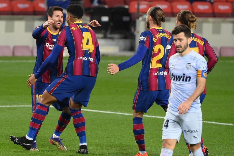 Barcelona's Ronald Araujo (2L) celebrates his goal with Lionel Messi. AFP