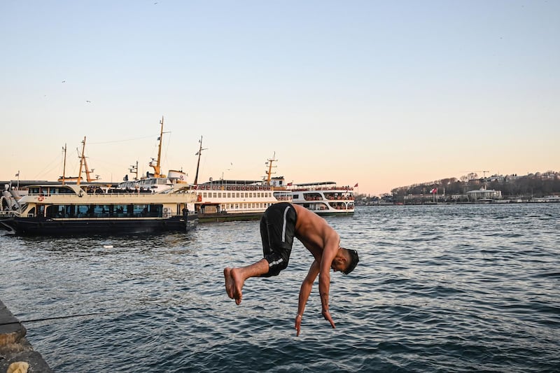 A Syrian refugee from Aleppo jumps into the Bosporus Strait at Karakoy district in Istanbul.  AFP