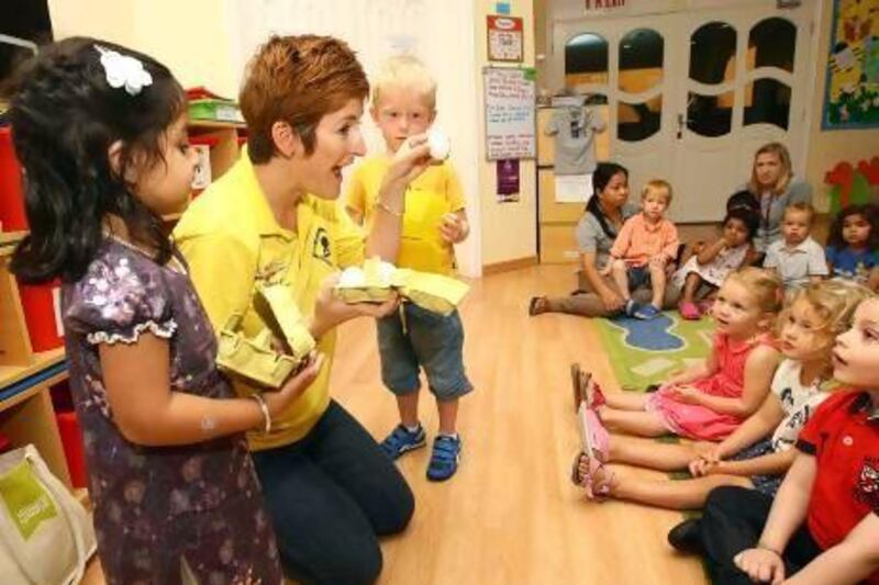 Lesley Cully, who runs the "Buckle Up in the Back" campaign, teaches toddlers at the Dovecote Nursery in Dubai about the importance of wearing their seat belts. Satish Kumar / The National