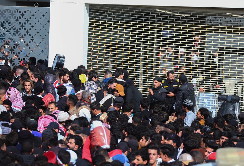 Iraqi football fans try to enter the Basra International Stadium, on Thursday.  A stampede outside the stadium  killed at least one person and injured several. AP