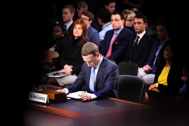 TOPSHOT - Facebook founder and CEO Mark Zuckerberg testifies during a Senate Commerce, Science and Transportation Committee and Senate Judiciary Committee joint hearing about Facebook on Capitol Hill in Washington, DC, April 10, 2018.
Facebook chief Mark Zuckerberg apologized to US lawmakers Tuesday for the leak of personal data on tens of millions of users as he faced a day of reckoning before a Congress mulling regulation of the global social media giant.In his first-ever US congressional appearance, the Facebook founder and chief executive sought to quell the storm over privacy and security lapses at the social network that have angered lawmakers and Facebook's two billion users.
 / AFP PHOTO / JIM WATSON