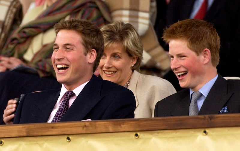 FILE - In this Monday, June 3, 2002 file photo, Britain's Prince William and Prince Harry enjoy the Party at the Palace concert in the gardens of Buckingham Palace, London, as the second concert to commemorate the Golden Jubilee of Britain's Queen Elizabeth II. Britain's royal officials said Thursday April 26, 2018, Prince Harry has asked elder brother Prince William to be best man at his wedding when he marries U.S. actress Meghan Markle at Windsor Castle on May 19. (AP Photo/Arthur Edwards/Pool)