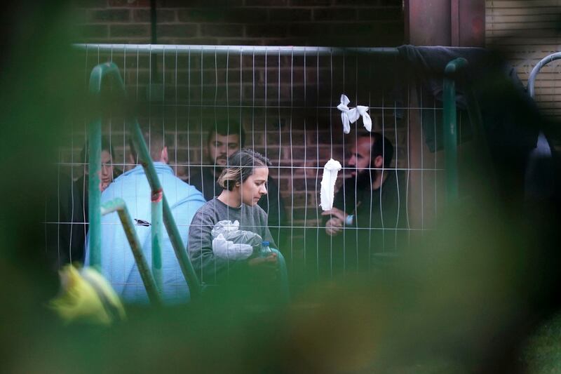 People thought to be migrants walk inside the Manston immigration short-term holding facility. AP