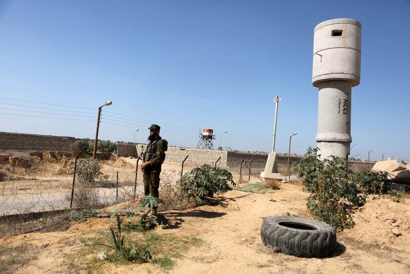 A Palestinian security officer patrols the Palestinian side of the Rafah border crossing in the southern Gaza Strip with Egypt on October 26, 2014. The decision was taken to close the Rafah crossing into the Gaza Strip, as Egypt declared a three-month state of emergency following a suicide car attack that killed 30 soldiers. Said Khatib/AFP Photo