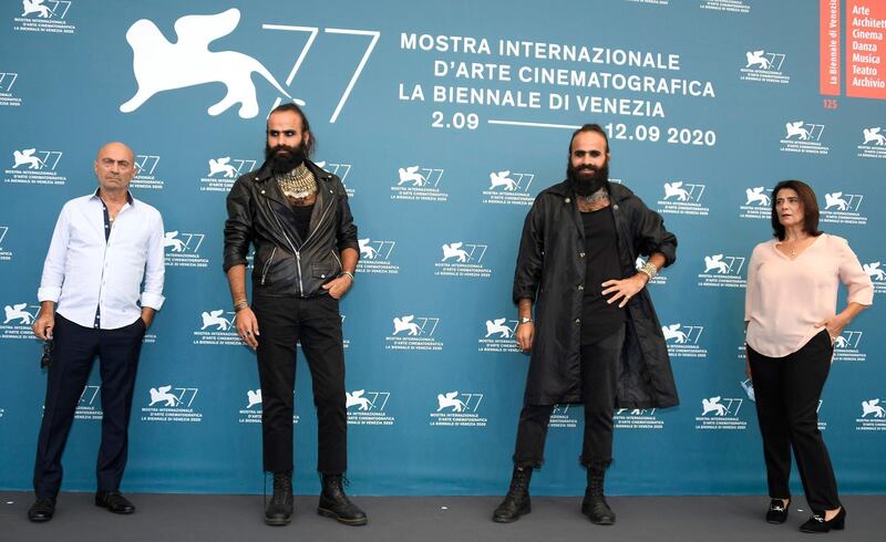 epa08645479 (L-R) Actor Salim Daw, Palestinian filmmaking brothers Tarzan and Arab Nasser and actress Hiam Abbas pose at a photocall for 'Gaza mon amour' at the 77th annual Venice International Film Festival, in Venice, Italy, 04 September 2020. The event is the first major in-person film fest to be held in the wake of the Covid-19 coronavirus pandemic. Attendees have to follow strict safety measures like mandatory face masks indoors, temperature scanners, and socially distanced screenings to reduce the risk of infection. The public is barred from the red carpet, and big stars are expected to be largely absent this year. The 77th edition of the festival runs from 02 to 12 September 2020.  EPA/CLAUDIO ONORATI