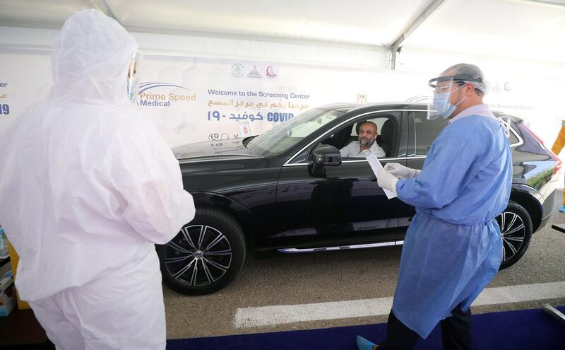 A health worker prepares to collect a sample at a drive-through Covid-19 screening centre at the Ain Shams field hospital in Cairo, Egypt.  EPA