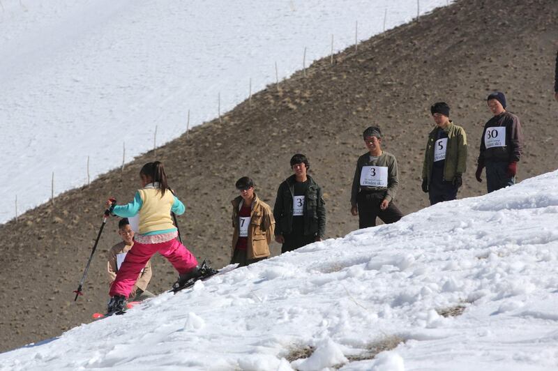 AFGHANISTAN, Bamiyan: 04 March 2021
Pictures from the annual Afghan Mountain Challenge - a ski event held in Bamiyan Province, 80 miles west of Kabul. Participants have to run up the mountain via specific checkpoints and then proceed to ski down. 
Pictured - A young competitor makes her way down the slope as she competes in the women's race. Rick Findler for The National