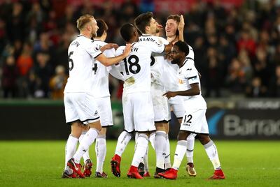 SWANSEA, WALES - JANUARY 22:  Alfie Mawson of Swansea City celebrates scoring his side's first goal with team mates during the Premier League match between Swansea City and Liverpool at Liberty Stadium on January 22, 2018 in Swansea, Wales.  (Photo by Michael Steele/Getty Images)