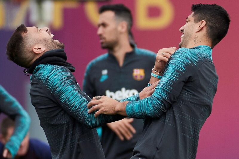 epa07940255 FC Barcelona's Jordi Alba (L) shares a light moment with teammate Luis Suarez (R) during a team's training session at Joan Gamper sport complex in Sant Joan Despi, Barcelona, Spain, 22 October 2019. The club prepares its upcoming UEFA Champions League group round soccer match against Slavia Prague at Prague's Eden Arena Stadium on 23 October.  EPA/Alejandro Garcia