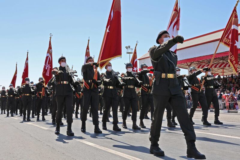 Mr Erdogan reviews a guard of honour with the Turkish Cypriot leader. Reuters