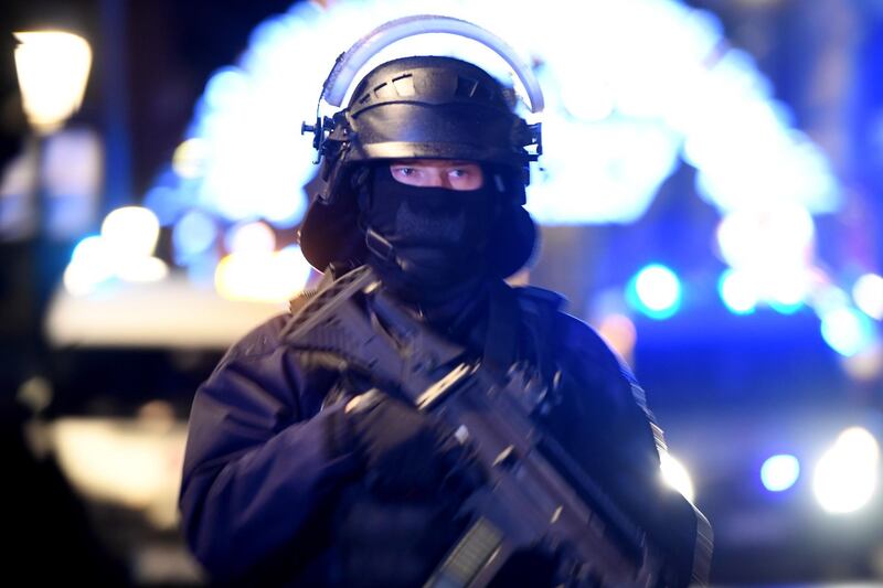 A police officer stands guard near the Christmas market. EPA