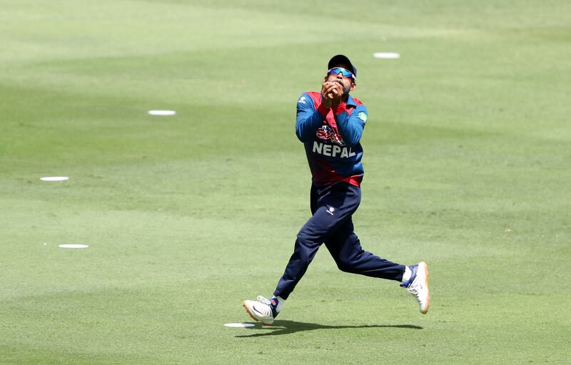 Nepal's Aarif Sheikh catches a shot off UAE batsman Zahoor Khan. 