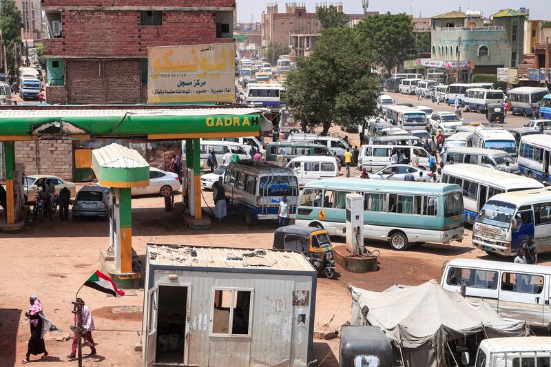 Vehicles queue at a petrol station in the south of Sudan's capital Khartoum.  AFP