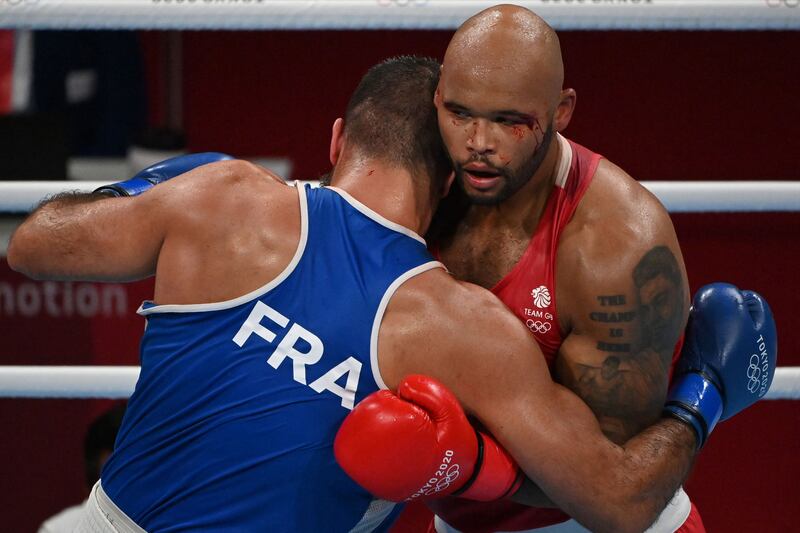 Britain's Frazer Clarke (red) and France's Mourad Aliev fight during their men's super heavy (over 91kg) quarter-final boxing match.