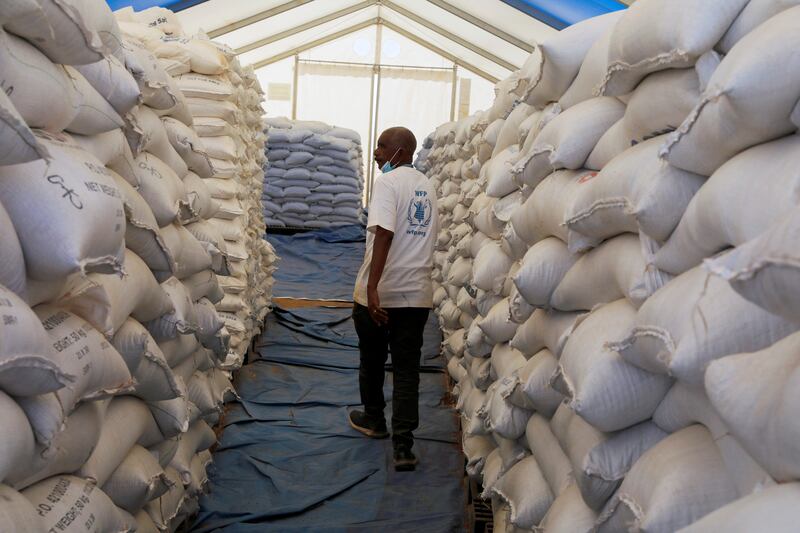 A WFP employee goes through food stocks at the Um Rakuba refugee camp that houses Ethiopian refugees in Sudan. Reuters