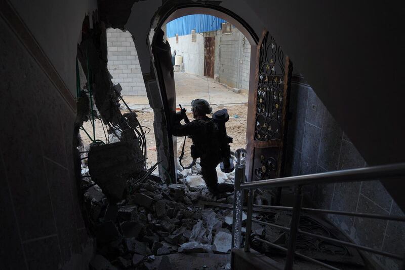 An Israeli soldier stands in a bombed-out building in the northern Gaza Strip. AFP / Israeli Army