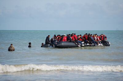 Migrants on an inflatable boat in northern France before trying to illegally cross the English Channel. AFP