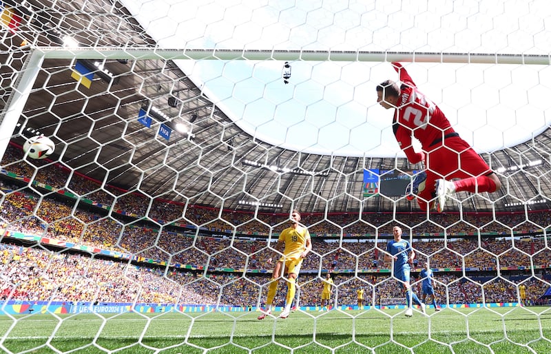 Ukraine's Andriy Lunin after the ball hit the crossbar from a corner kick taken by Romania's Nicolae Stanciu. Reuters