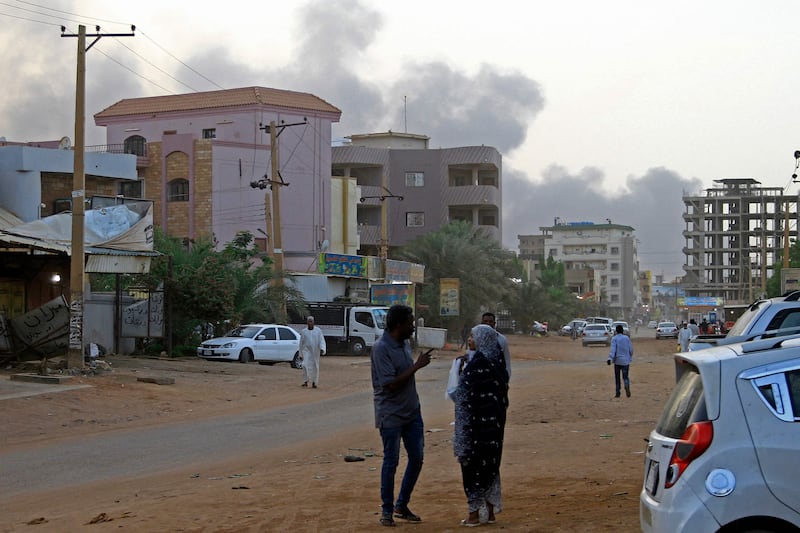 Smoke billows above residential buildings in Khartoum, as fighting in Sudan raged for a second day. AFP