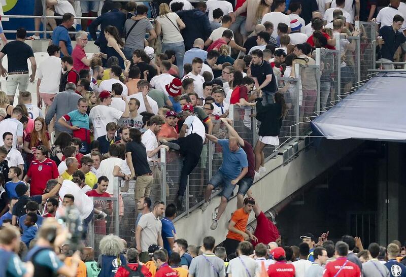 Spectators try to escape from the stands as clashes broke out right after the Euro 2016 Group B soccer match between England and Russia, at the Velodrome stadium in Marseille, France. Claude Paris / AP