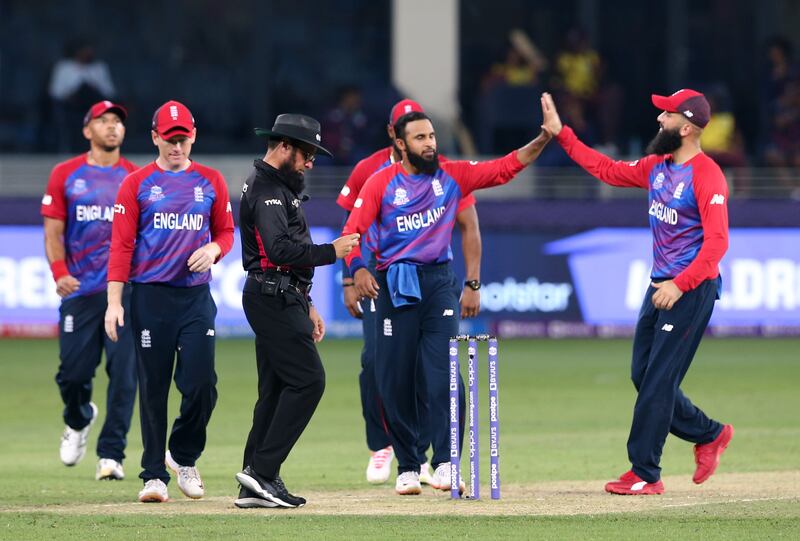 England's Adil Rashid celebrates with teammates after taking the wicket of West Indies' Obed McCoy. Reuters