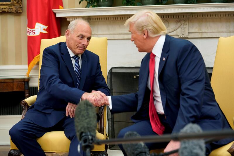 U.S. President Donald Trump shakes hands with John Kelly after he was sworn in as White House Chief of Staff in the Oval Office of the White House in Washington, U.S., July 31, 2017. REUTERS/Joshua Roberts     TPX IMAGES OF THE DAY