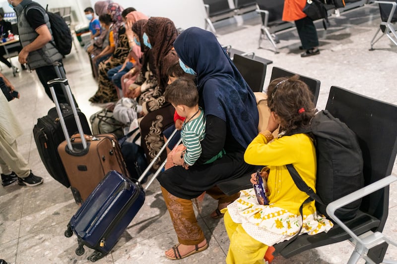 Refugees from Afghanistan wait to be processed after arriving on an evacuation flight at London's Heathrow airport in 2021. Getty Images