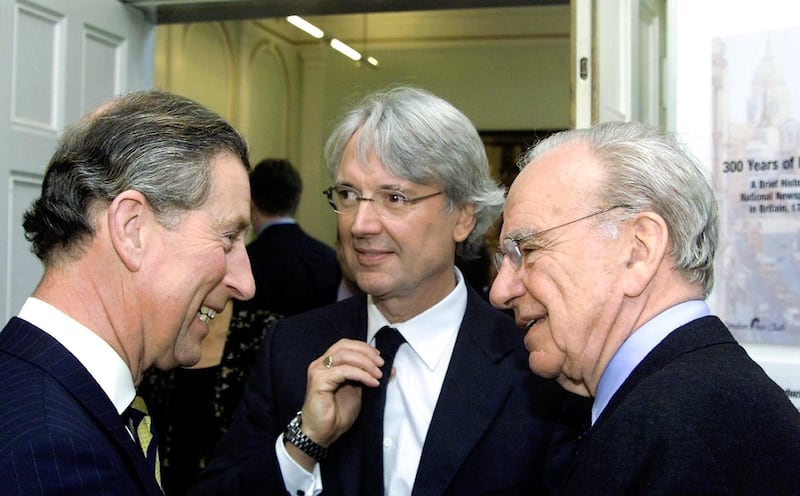 (FILES) The Prince of Wales (L) meets with the President of News Corp. Rupert Murdoch (R) and Les Hinton (C), Chairman of News International, at the end of a service at St Bride's Church in this March 11, 2002, file photo in London's Fleet Street. Hinton, now CEO of Dow Jones & Co., resigned his post at the financial information firm on July 15, 2011, according to the Wall Street Journal. Hinton is the latetst Murdoch empire top executive to leave in the wake of the phone hacking scandal. Hinton headed News Corp. when the first hacking allegations arose. News Corp. acquired Dow Jones in 2007.   FILES/POOL/MAX NASH
 *** Local Caption ***  429708-01-08.jpg