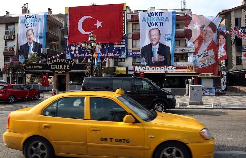 Cars drive past posters for presidential candidates Turkey's President and ruling Justice and Development Party, or AKP, leader Recep Tayyip Erdogan, left, and Meral Aksener, the presidential candidate of nationalist opposition Iyi (Good) Party in Ankara, Turkey, on June 24, 2018. Ali Unal / AP Photo