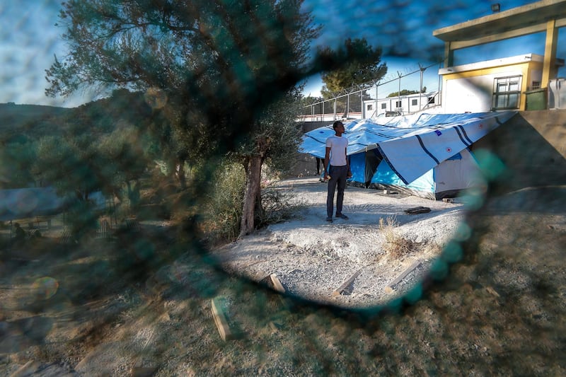 Marmaro, Mytilene, Greece, September 12, 2018.  The Moria "Open" refugee camp.  A refugee of the "open' camp.  The "real" Moria camp is behind, the enclosed area with a fence with cyclone wire. 
Victor Besa/The National
Section:  WO
Reporter:  Anna Zacharias