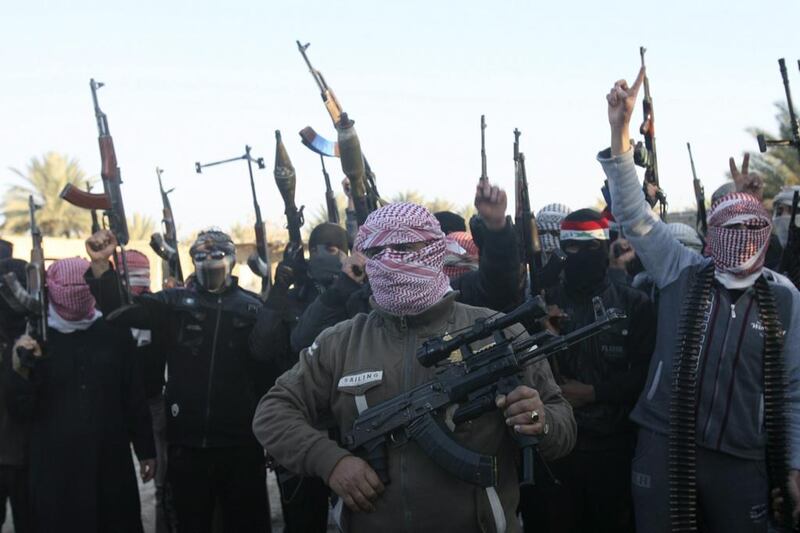 Masked Sunni gunmen chant slogans during a protest against Iraq's Shia-led government. Ali Suleiman / Reuters