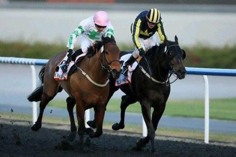 Silvestre de Sousa, in white, takes Hitchens home in the Al Shindagha sprint yesterday.