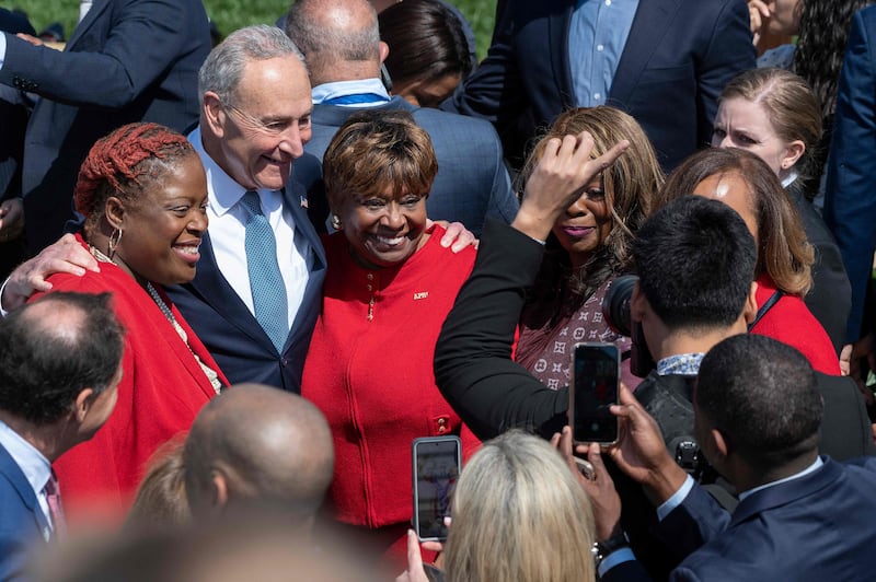 Senator Chuck Schumer poses with guests at an event celebrating Ms Jackson's confirmation to the US Supreme Court. AFP