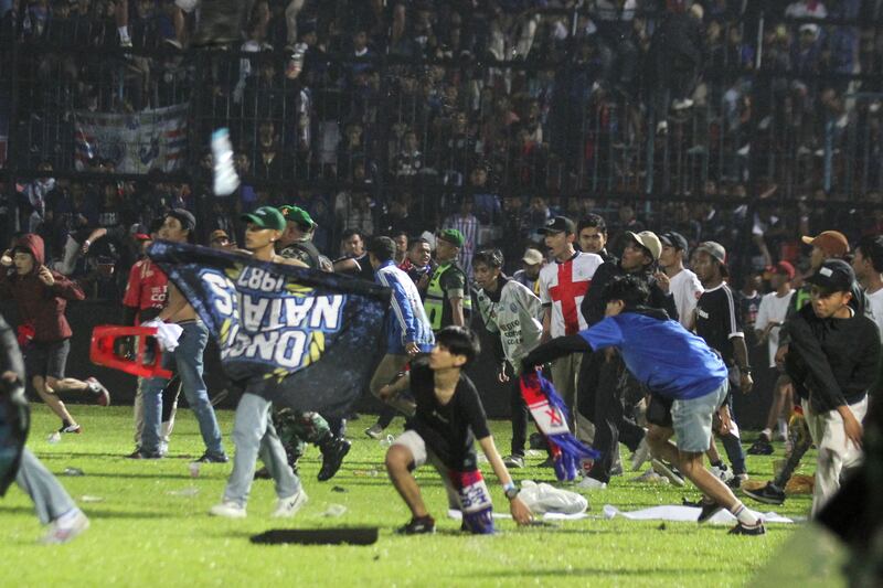 Arema FC supporters enter the field after the team they support lost to Persebaya on October 2. Reuters