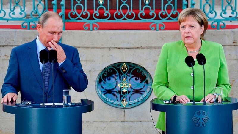 German Chancellor Angela Merkel and Russian President Vladimir Putin give a statement on August 18, 2018 at Schloss Meseberg castle in Meseberg, northeastern Germany, where they meet to discuss conflicts in Syria and Ukraine as well as energy issues. (Photo by John MACDOUGALL / AFP)