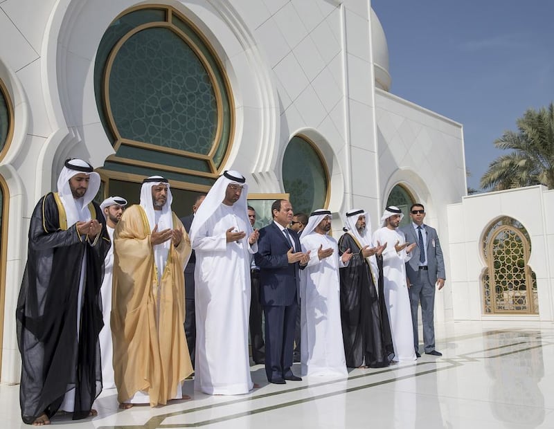 Abdel Fattah El Sisi, president of Egypt, centre, prays at the tomb of the Sheikh Zayed,near the Grand Mosque on Wednesday. Among those who accompanied him are Dr Sultan Al Jaber, third from left, Minister of State, Chairman of Masdar and Chairman of the Abu Dhabi Ports Company, Mohammed Al Dhaheri, fifth from left, the UAE Ambassador to Egypt, and Dr Hamdan Al Mazrouei, second left, chairman of the board of directors of the Emirates Red Crescent. Mohamed Al Hammadi / Crown Prince Court – Abu Dhabi