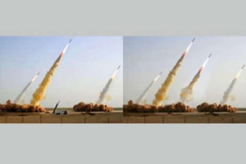 The photo on the left shows three missiles rising into the air while a fourth remains in the launcher on the ground during a test-firing. The photo on the right shows the same image, apparently digitally altered to replace the grounded missile and launcher with a fourth successfully launched missile.